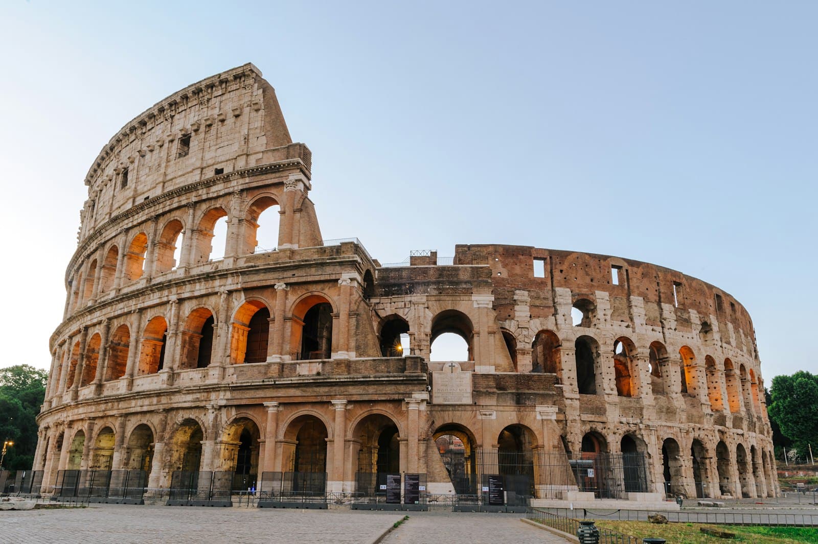 The Colosseum in Rome under a clear sky at golden hour
